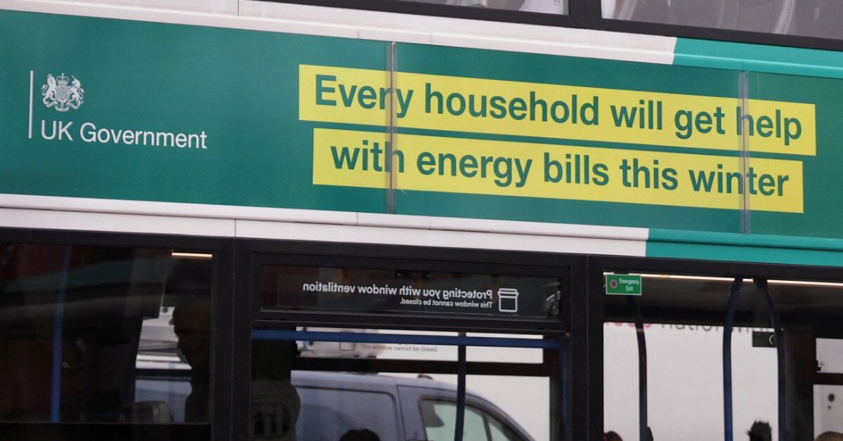 The side of a bus with a green UK Government advert with a yellow banner that says 'Every household will get help with energy bills this winter'